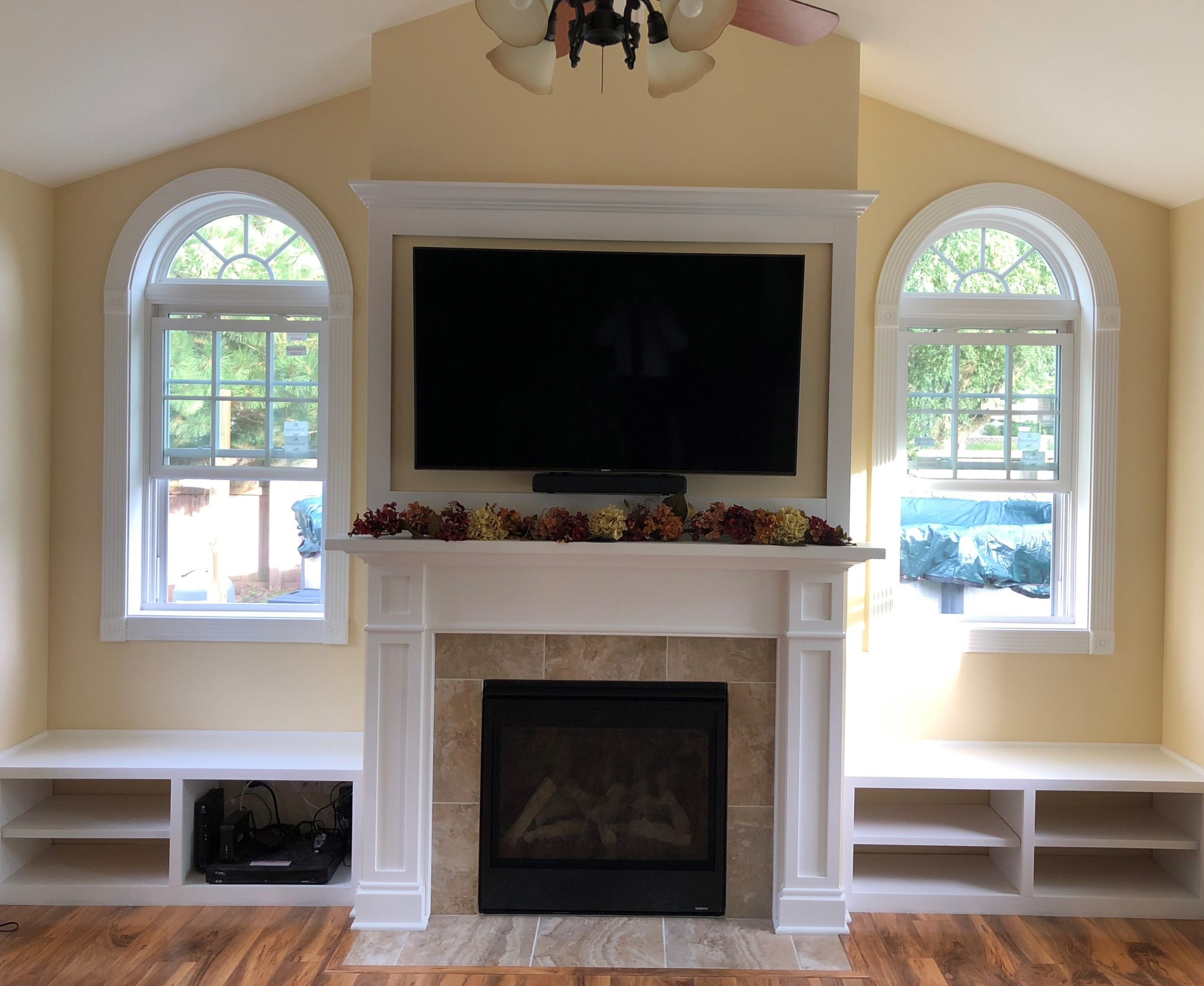 Fireplace with TV above in a vaulted room