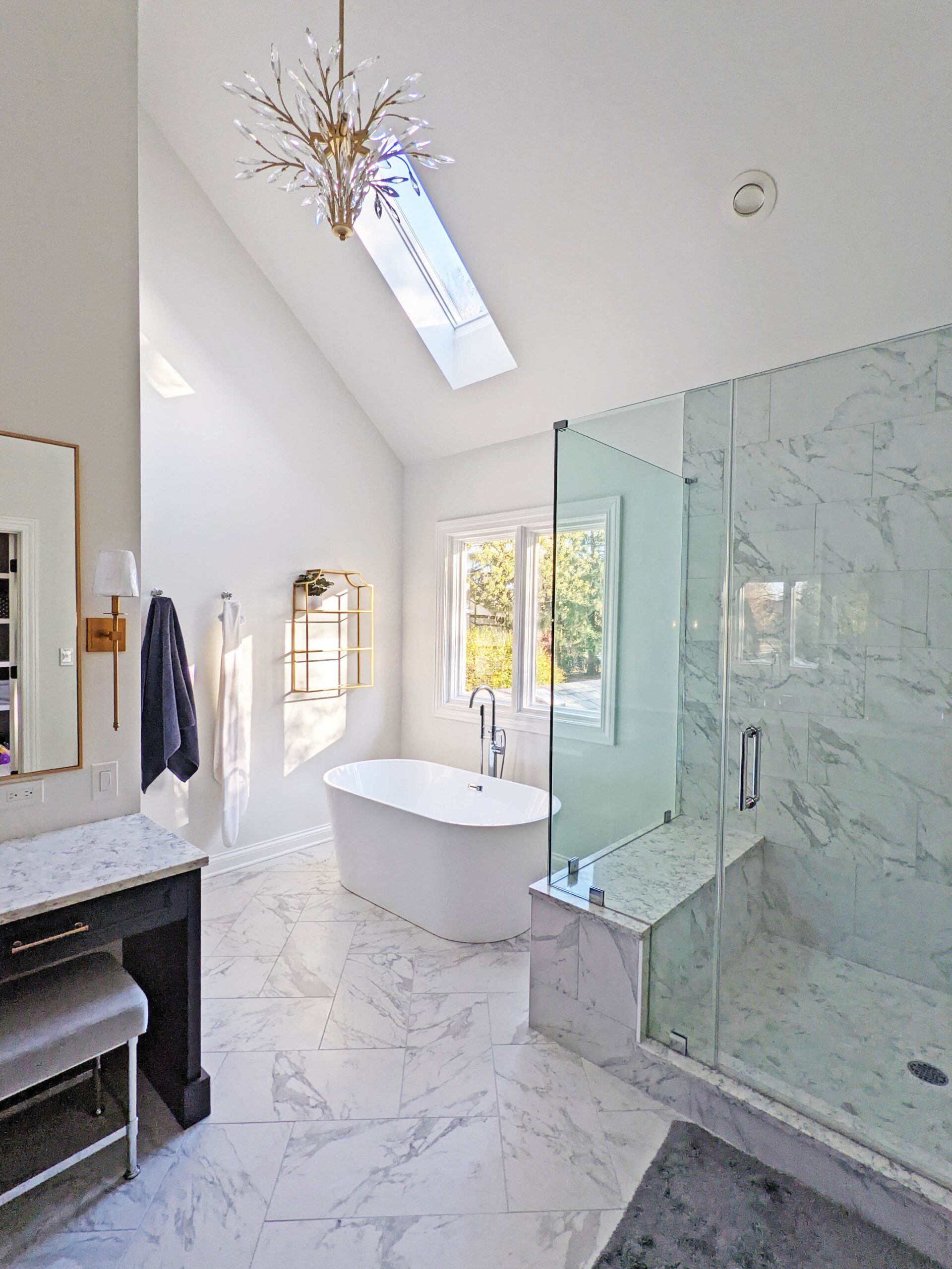Primary bathroom with vaulted ceilings, freestanding bathtub, separate shower